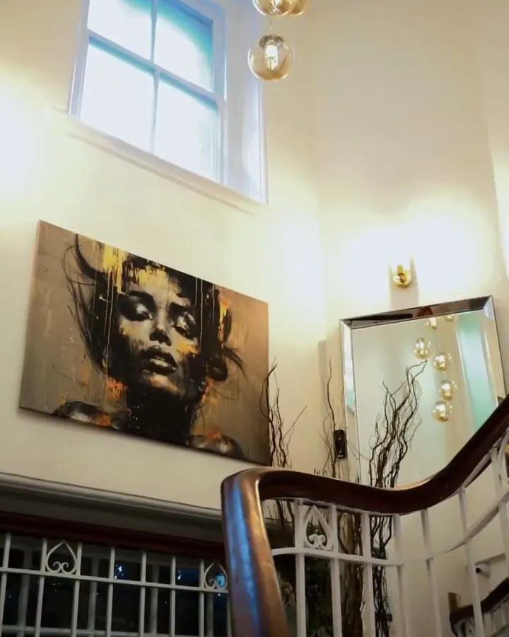 Sunlit stairwell with a pendant light and artwork inside ZARA Aesthetic Medical Clinic