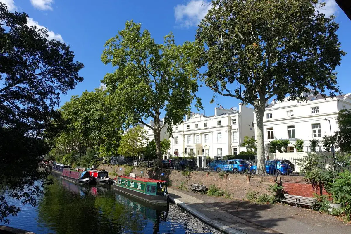 Narrowboats moored on the canal beside white townhouses in Little Venice