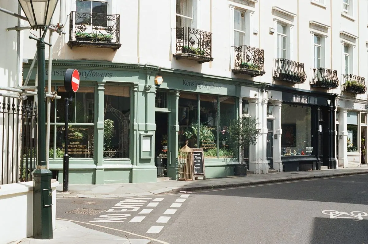White stucco terrace and corner shopfront on a quiet central London street