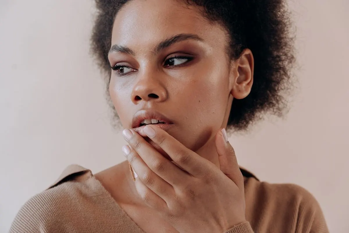 Portrait of a woman with defined cheekbones and natural curls