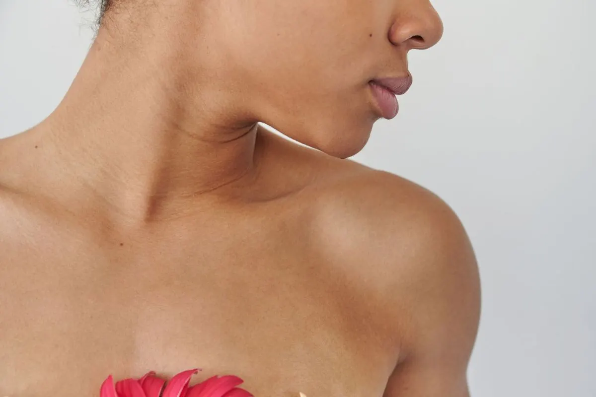 Profile of a woman's chin and neck against a white background