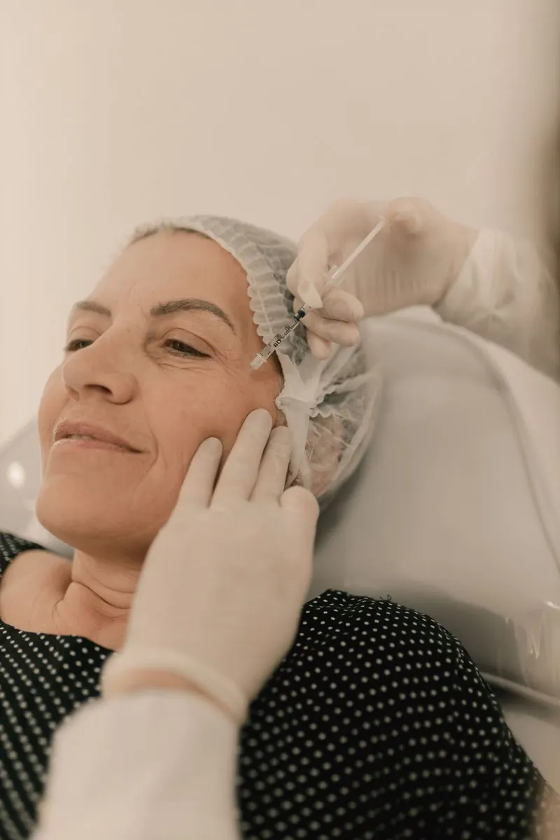 Smiling woman during a PRP facial injection treatment