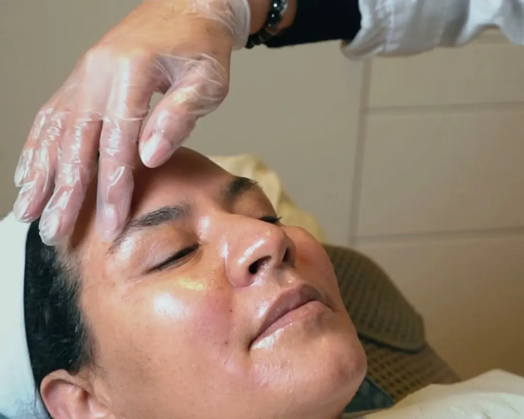 Client relaxing with glowing skin during a skin treatment